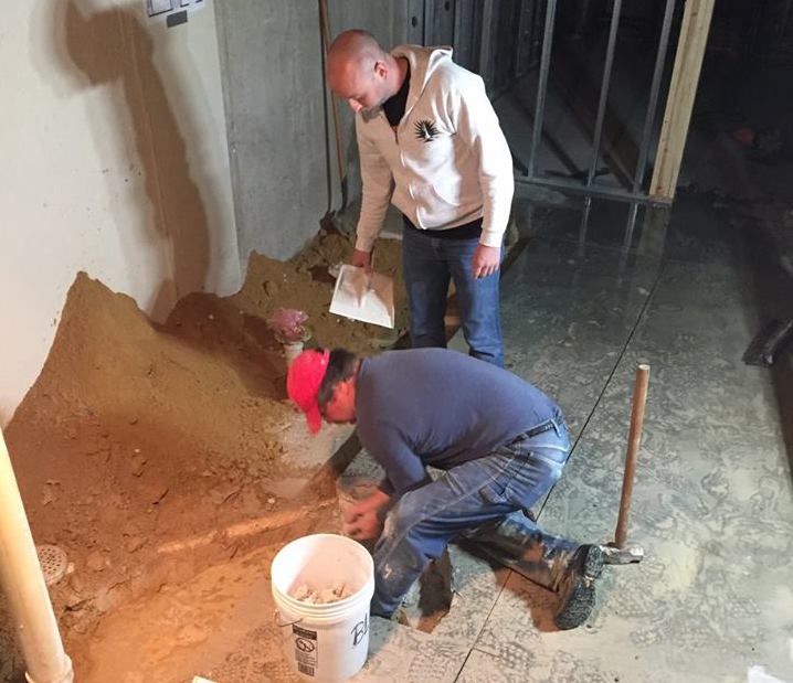 Cutting out the concrete in the basement to re-plumb and re-build the bathroom.
