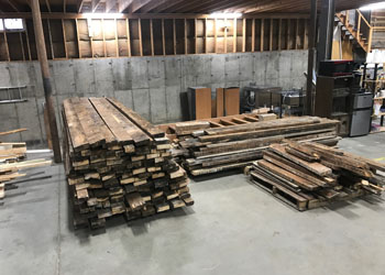 The old firehouse wood is neatly stacked and de-nailed. We'll use this to create various desks and tables for the new offices.