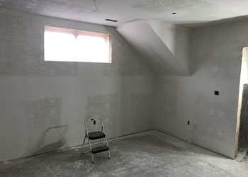 Taping, mudding, and priming is done in the downstairs offices.